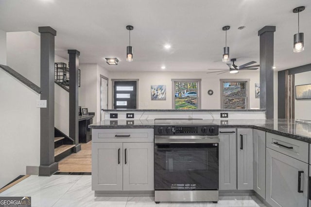 kitchen featuring gray cabinetry, pendant lighting, dark stone counters, and stainless steel electric range