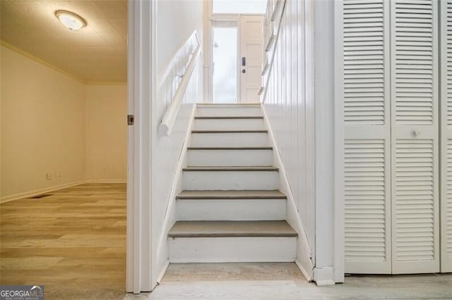 stairs featuring hardwood / wood-style floors