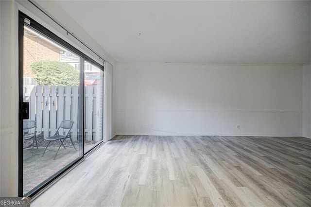 unfurnished room with light hardwood / wood-style flooring