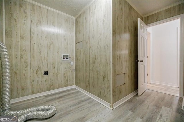 laundry room featuring crown molding, washer hookup, wood-type flooring, and electric dryer hookup