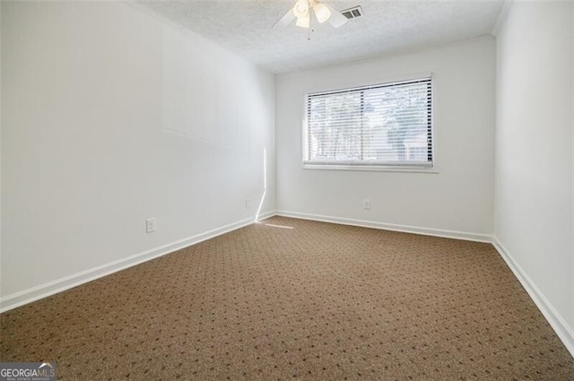 unfurnished room featuring ceiling fan and a textured ceiling