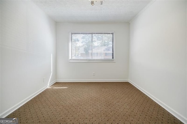 unfurnished room featuring a textured ceiling