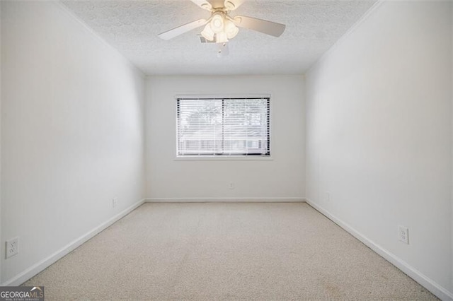 unfurnished room featuring ceiling fan, light colored carpet, and a textured ceiling