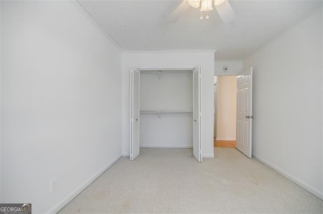 unfurnished bedroom featuring light colored carpet, a closet, and ceiling fan