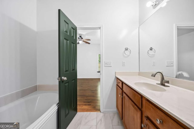 bathroom featuring a tub to relax in and vanity