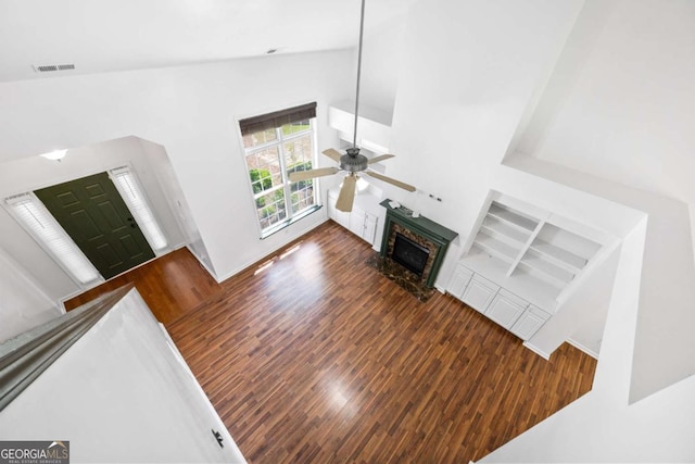 living room featuring ceiling fan, dark hardwood / wood-style floors, and high vaulted ceiling