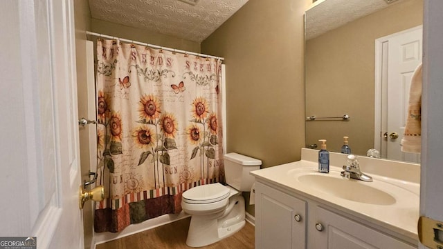 bathroom with vanity, hardwood / wood-style floors, a textured ceiling, and toilet