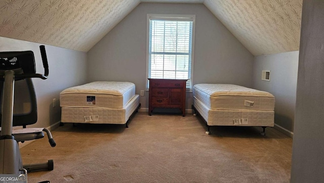 carpeted bedroom with vaulted ceiling and a textured ceiling