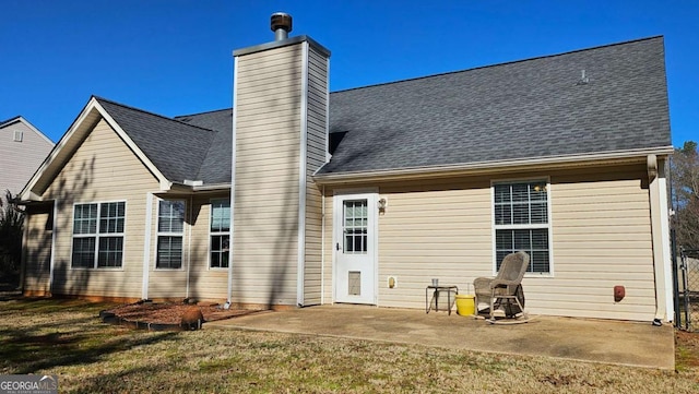 back of property featuring a yard and a patio area