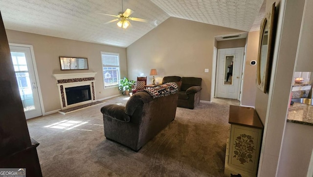 living room with ceiling fan, lofted ceiling, and carpet flooring