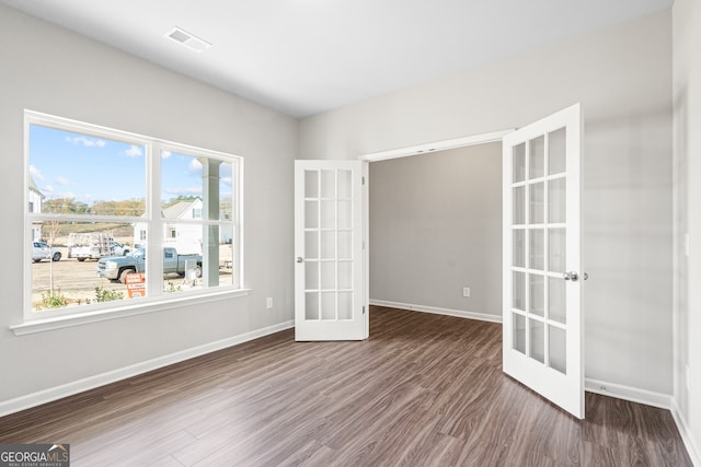 empty room with french doors and dark hardwood / wood-style floors