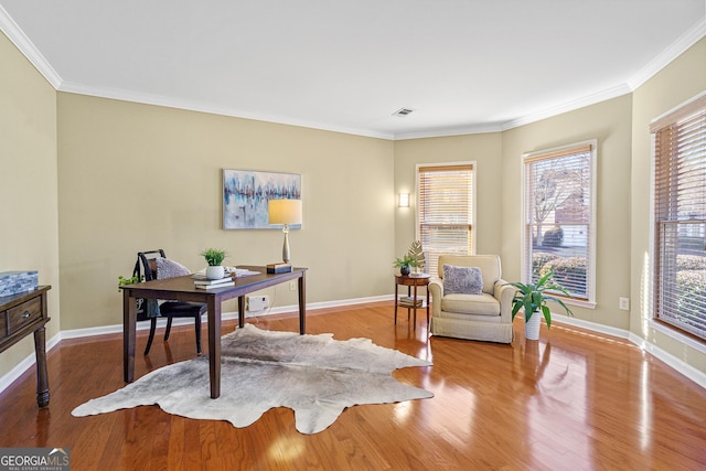 home office with hardwood / wood-style flooring and crown molding