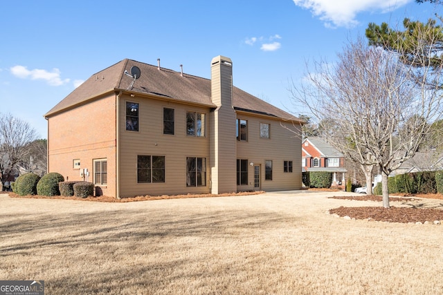 back of house featuring a yard