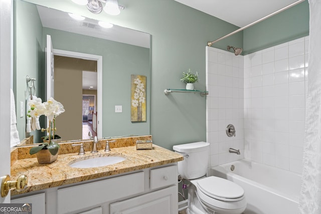 full bathroom with vanity, shower / tub combo with curtain, and toilet