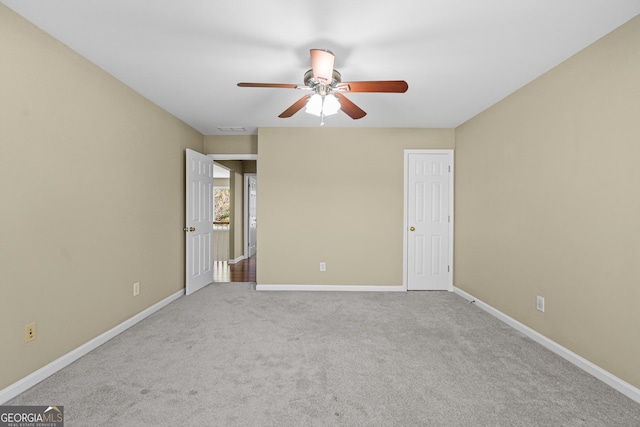 carpeted empty room featuring ceiling fan