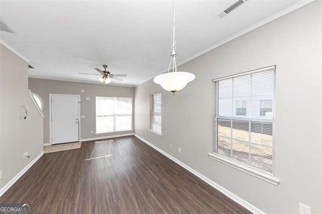 unfurnished room featuring dark hardwood / wood-style flooring, crown molding, and ceiling fan