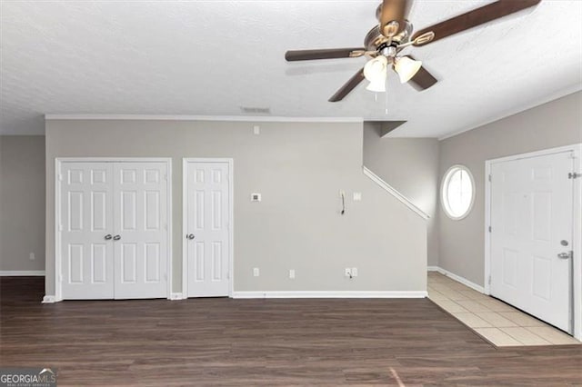 foyer featuring dark wood-type flooring, a textured ceiling, and ceiling fan