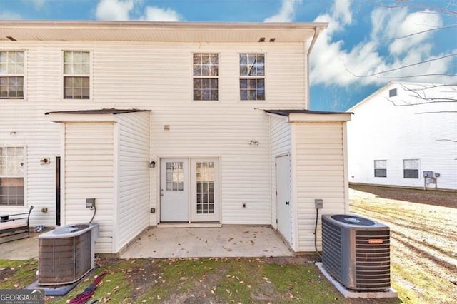 rear view of property featuring central AC and a patio area