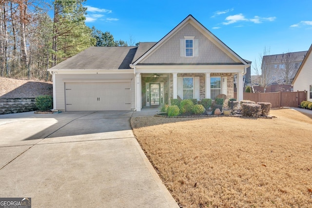 view of front of house featuring a garage, a front lawn, and a porch