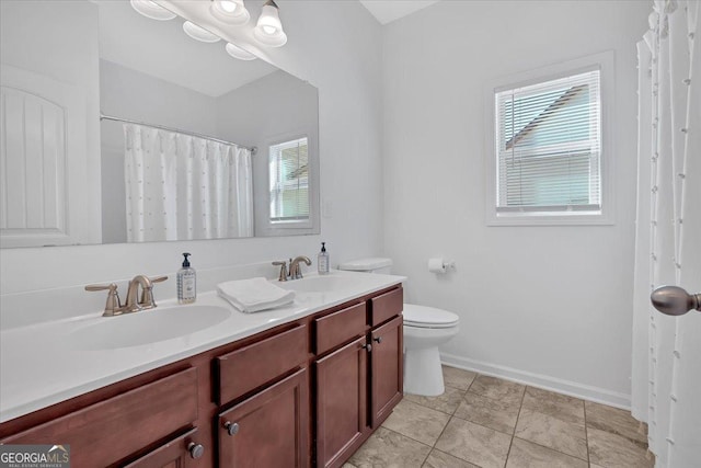 bathroom with vanity, tile patterned flooring, and toilet