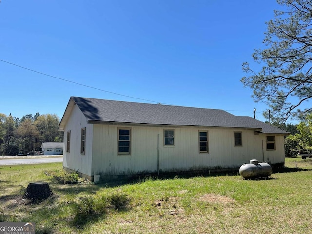 view of side of property with a lawn