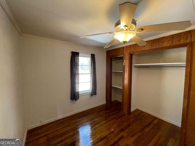 unfurnished bedroom featuring dark wood-type flooring, ceiling fan, and crown molding