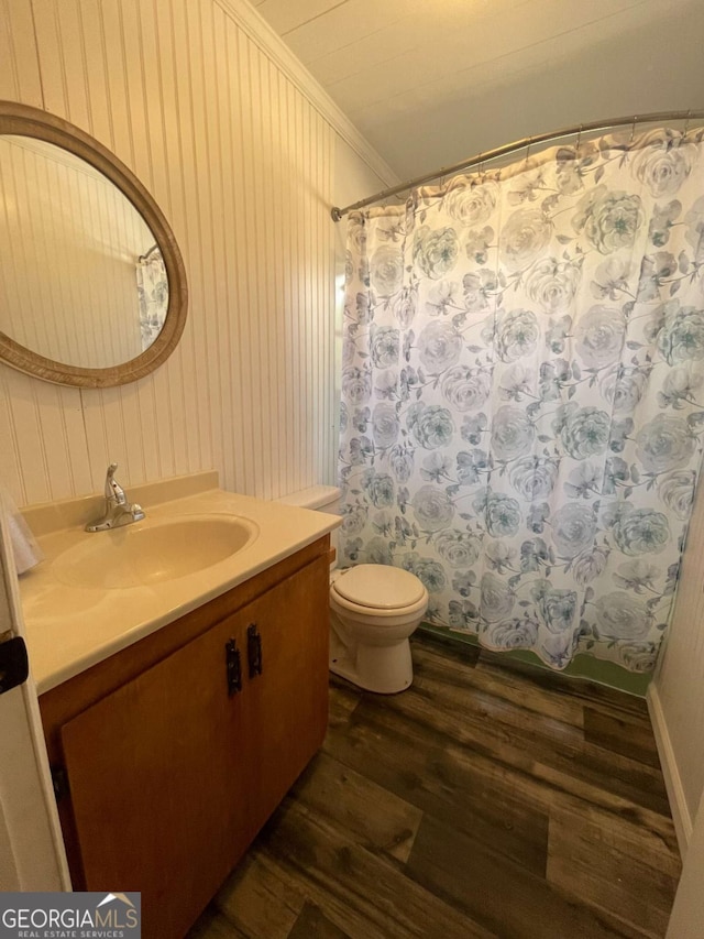 bathroom with wood-type flooring, ornamental molding, vanity, toilet, and a shower with curtain