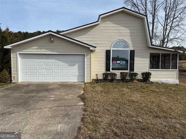 view of front of property featuring a garage and a front lawn