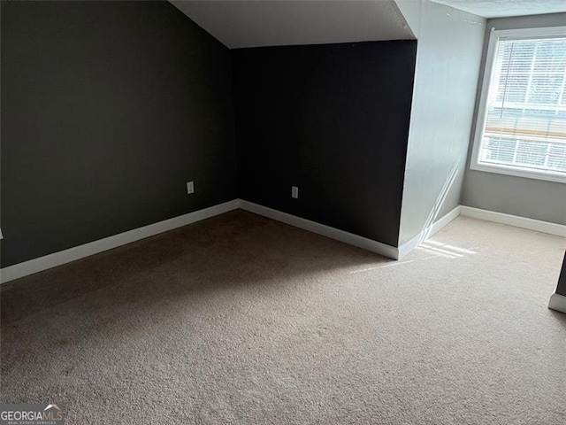 interior space featuring vaulted ceiling and carpet flooring