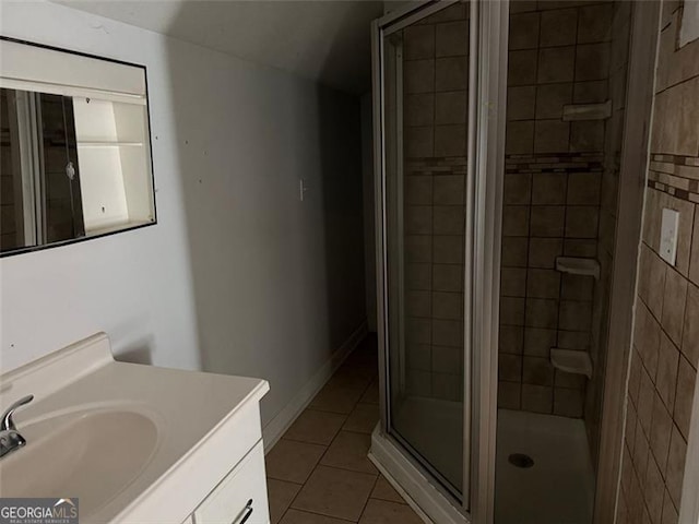 bathroom with tile patterned floors, a shower with shower door, and vanity