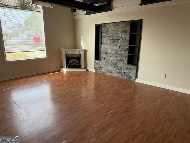 unfurnished living room featuring hardwood / wood-style floors and a wealth of natural light