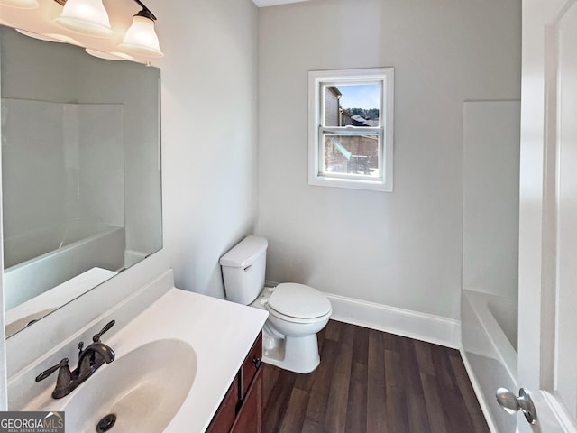 bathroom with vanity, wood-type flooring, and toilet