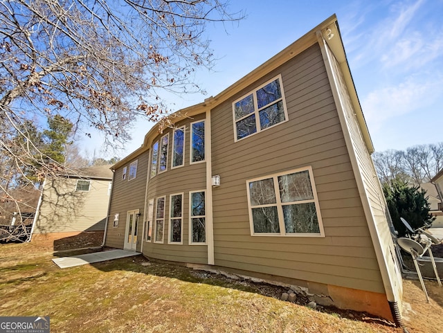 rear view of house with a yard and a patio