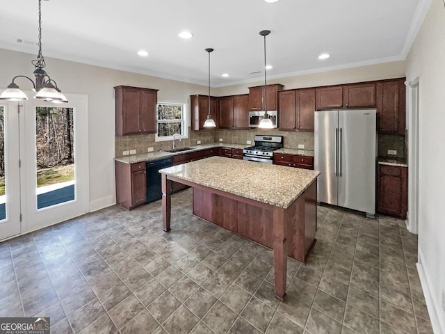 kitchen featuring a kitchen bar, sink, decorative light fixtures, a center island, and stainless steel appliances