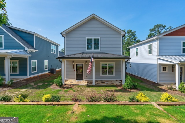 view of front of property with cooling unit, a front yard, and a porch