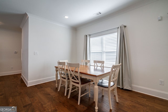 dining room with crown molding and dark hardwood / wood-style flooring