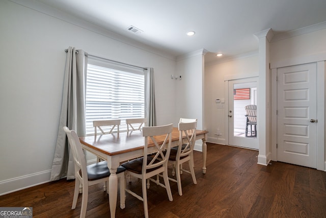 dining room with ornamental molding and dark hardwood / wood-style floors