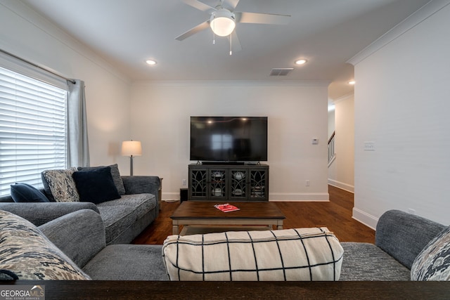 living room featuring dark wood-type flooring, ceiling fan, and crown molding