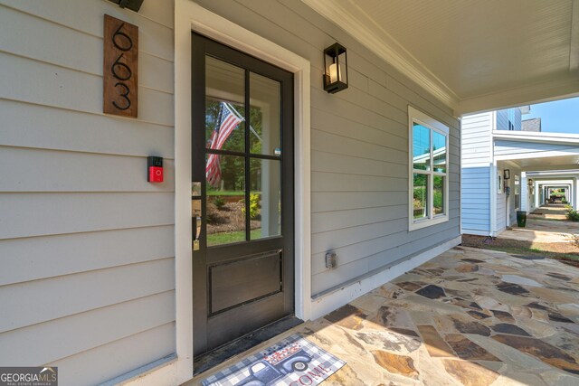 view of exterior entry with covered porch