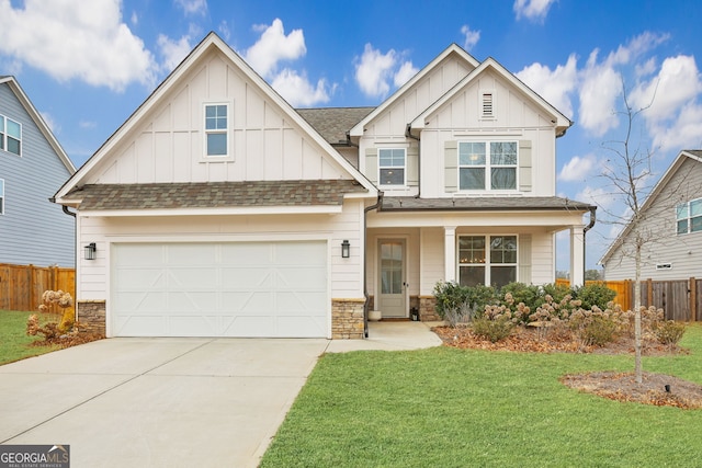 craftsman-style house featuring a garage, a front yard, and covered porch