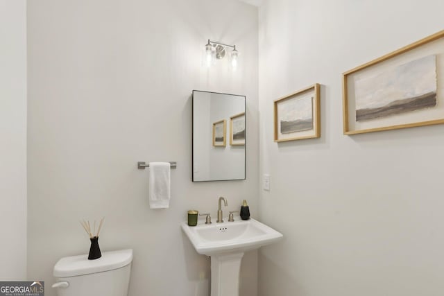 bathroom featuring sink and toilet