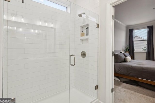 bathroom with walk in shower, a healthy amount of sunlight, and ornamental molding