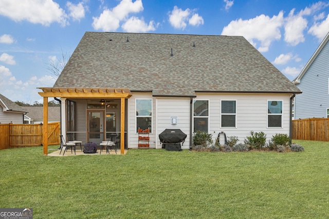 back of property featuring a sunroom, a patio, and a lawn