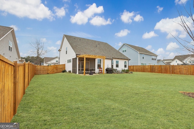 back of property with a lawn and a sunroom