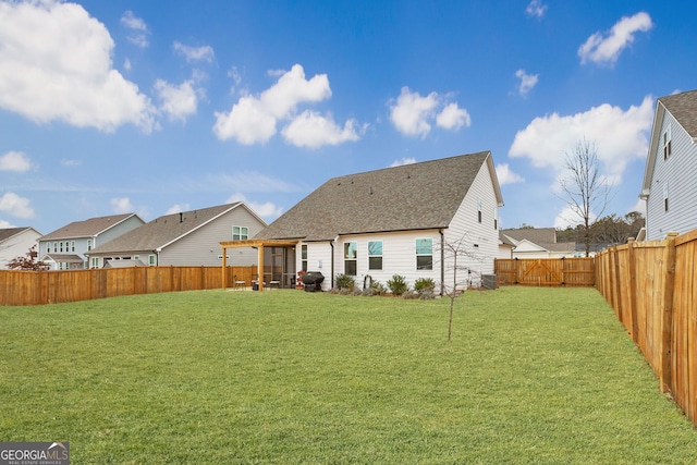 rear view of property featuring a lawn