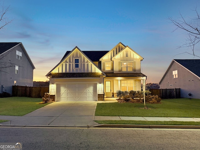 view of front of home with a garage and a yard