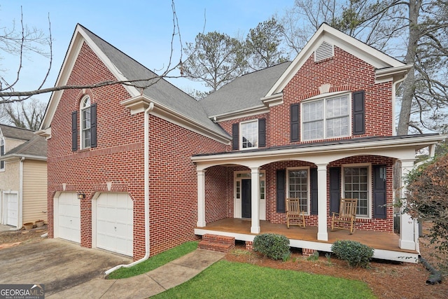 view of property featuring a porch and a garage