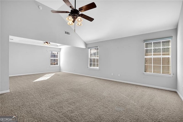 carpeted empty room featuring ceiling fan, visible vents, high vaulted ceiling, and baseboards