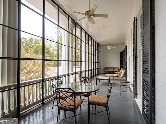 sunroom featuring a wealth of natural light and ceiling fan