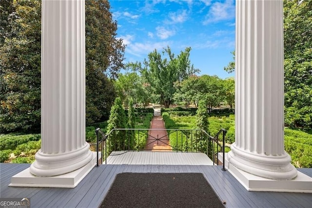 exterior space featuring decorative columns